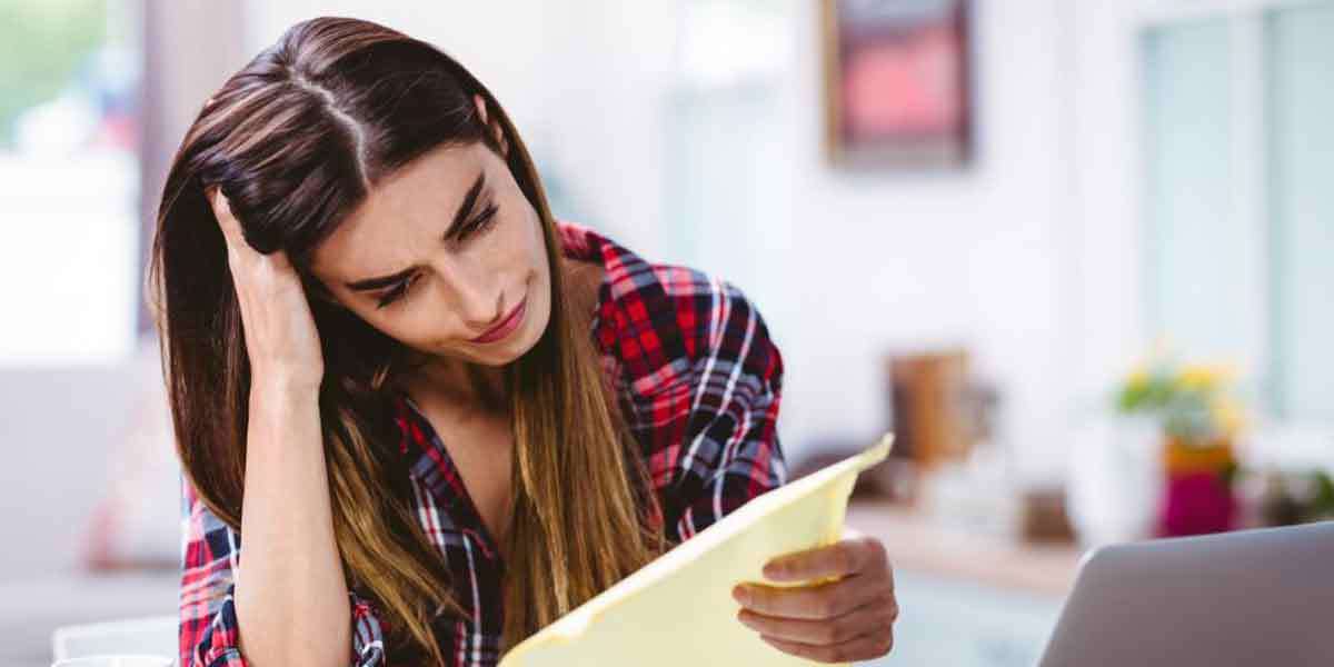 Woman holding head in hands
