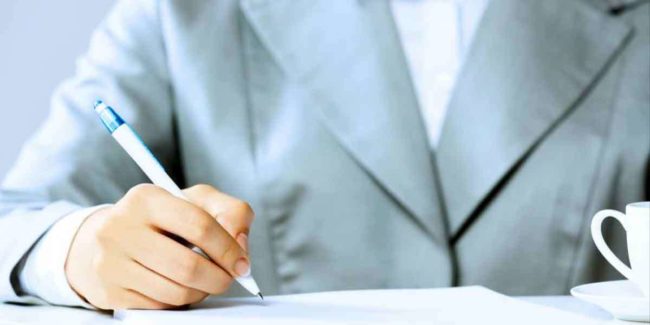 A woman signing documents
