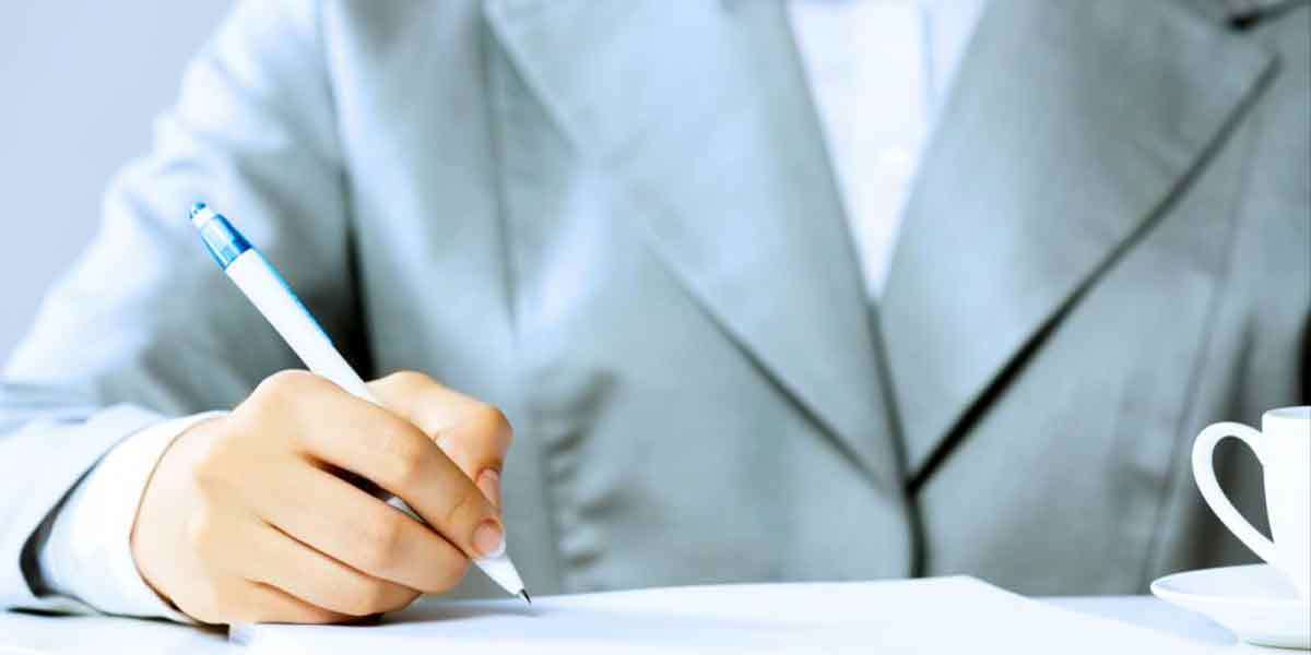 A woman signing documents